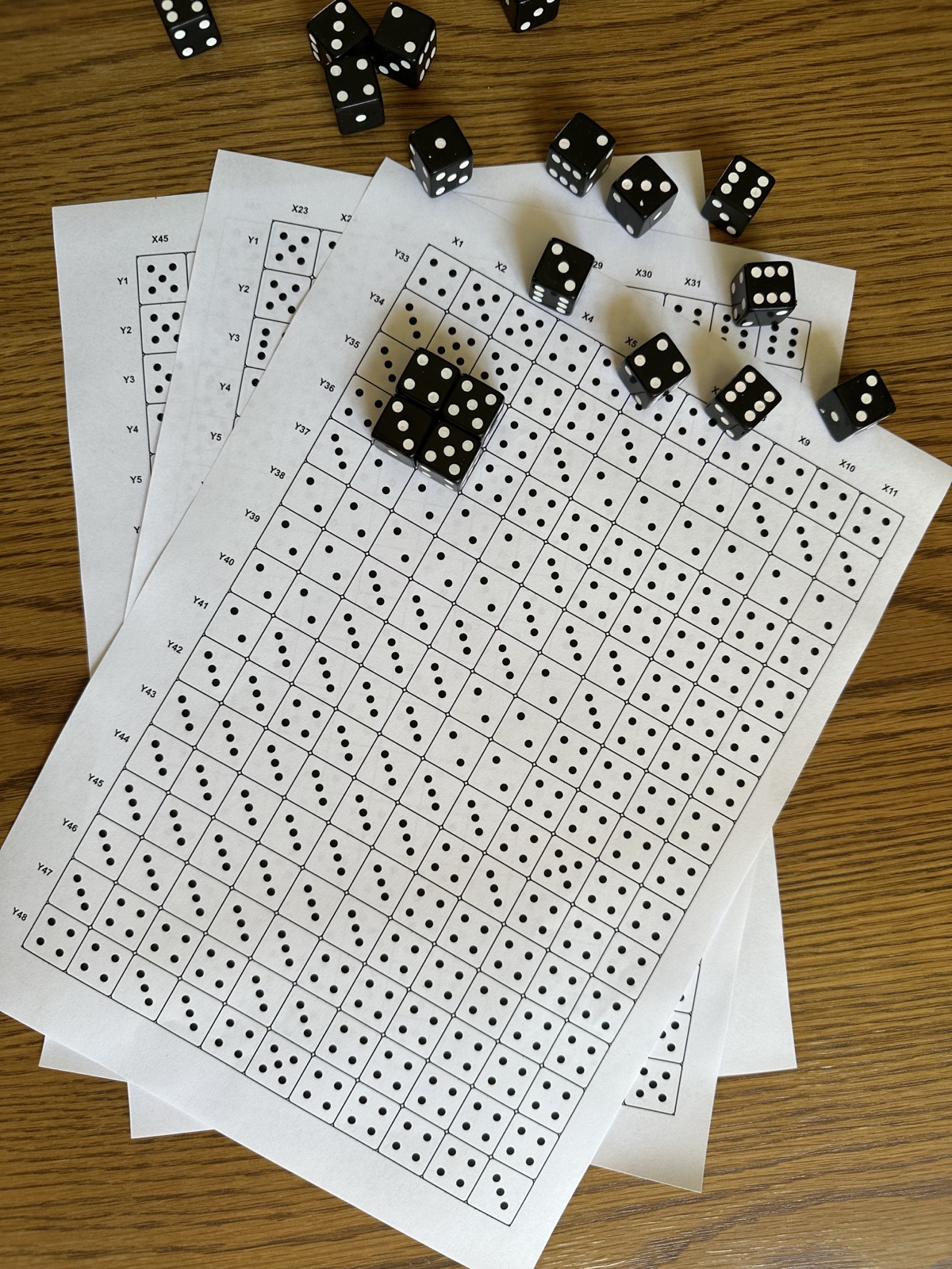Printed Kostka Pixel instruction sheets with X and Y grid coordinates